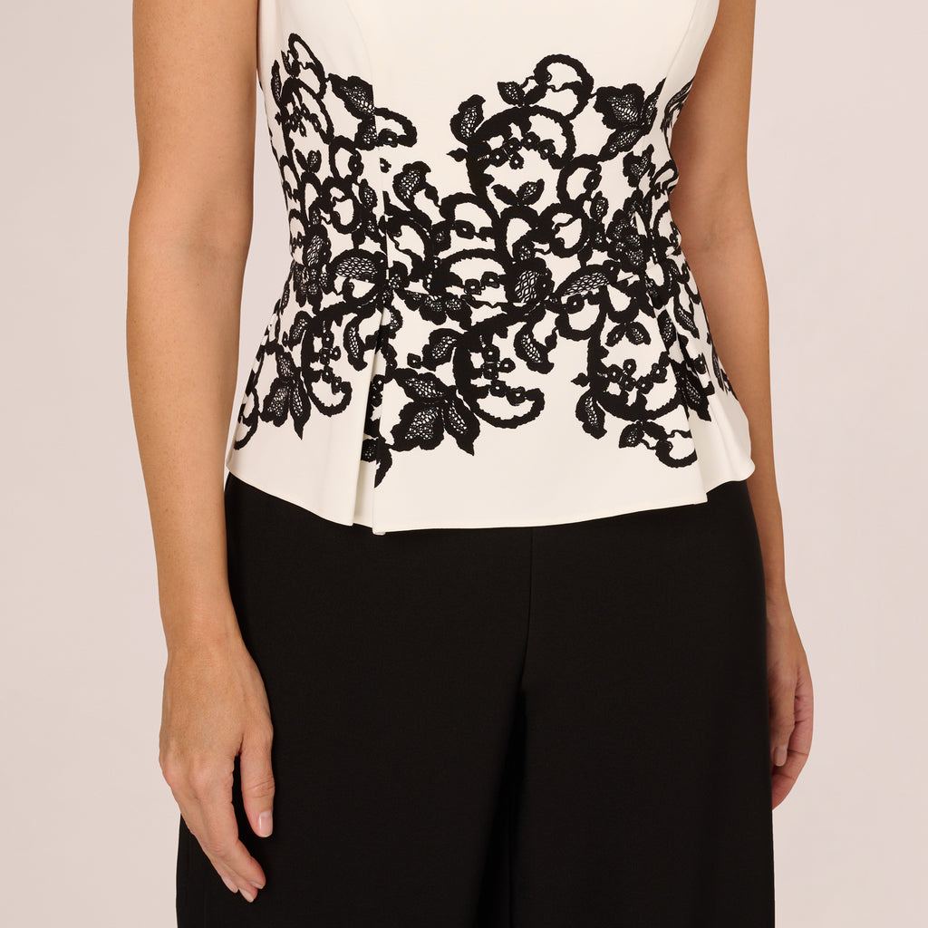 Sleeveless Peplum Jumpsuit With Scroll Lace Details In Ivory Black Adrianna Papell