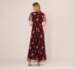 burgundy floral flocked glitter sheer knot detail maxi dress ASOS DESIGN floral flock maxi dress with flute sleeve detail in burgundy