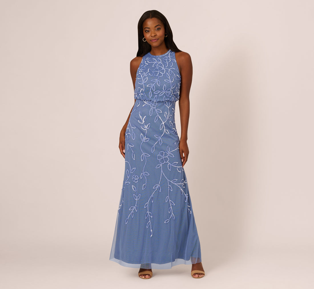 Blue beaded mermaid gown with a bloused sleeveless bodice and a skirt that flares below the thighs
